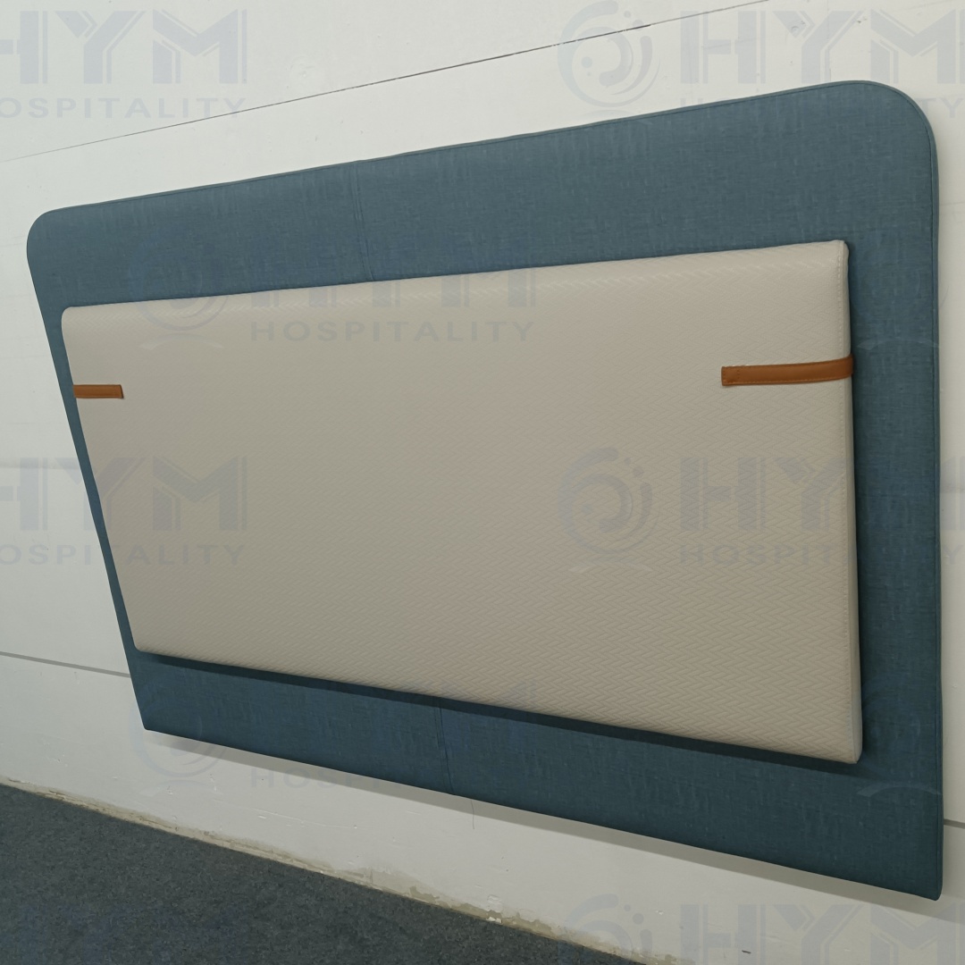 Close-up of a wall-mounted double-stacked headboard showing the railroaded vinyl pattern and rounded top corners for Homewood Suites compliance.