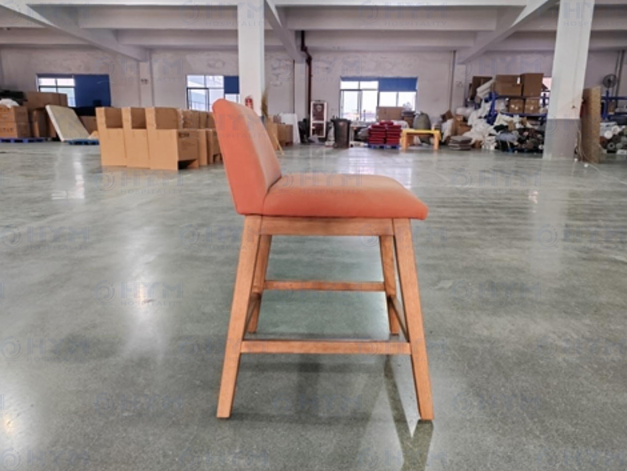 Side view of PA-109 stool production sample in a factory showroom, showing real-world Sap Walnut finish.