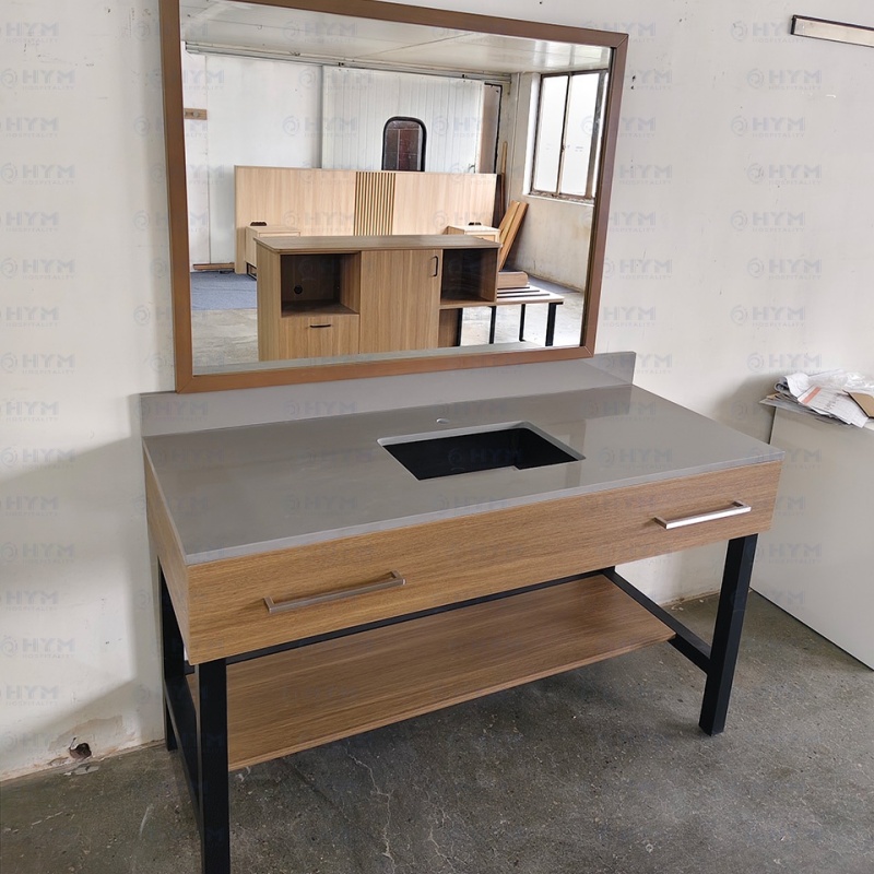 Contract-grade hotel vanity for PIP renovations featuring Tiger Drylac Matte Black metal tube legs and a durable wood-grain HPL shelf for guestroom bathrooms.