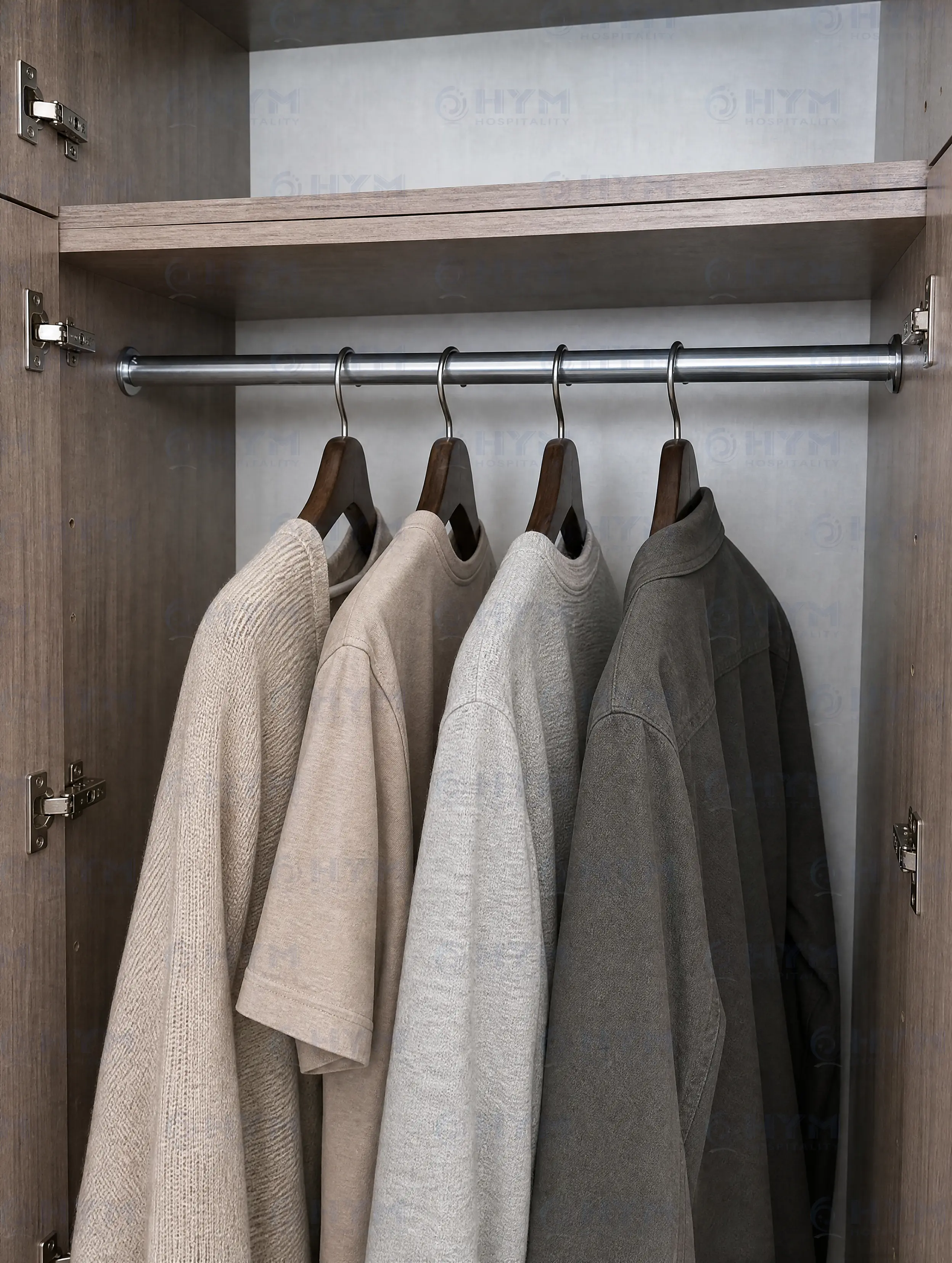 Close-up of the GR-321 oval hanging rod designed for long-garment hanging behind full-height closet doors in Hilton studio suites.
