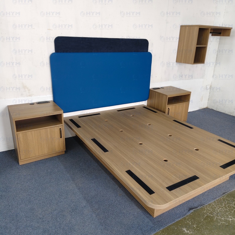 Factory staging of Hampton by Hilton Forever Young guestroom FF&E collection including King nightstand, bed base, and headboard panels.