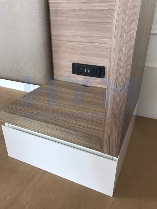 SpringHill Suites nightstand detail with integrated black AC and USB power outlets by HYM Hospitality