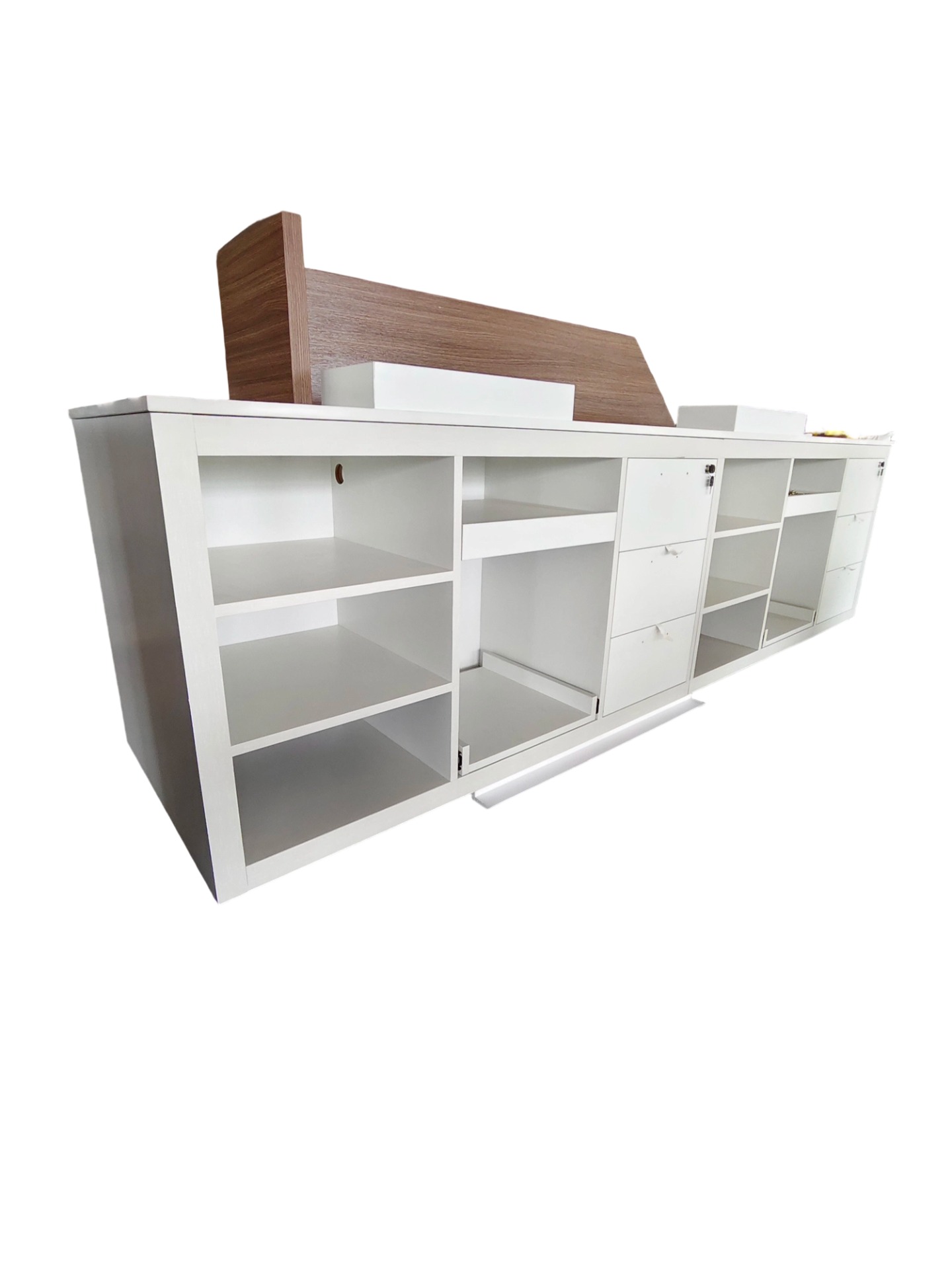 Rear operational view of Holiday Inn Express check-in desk showing modular storage cubbies and locking drawer systems for front-desk efficiency.