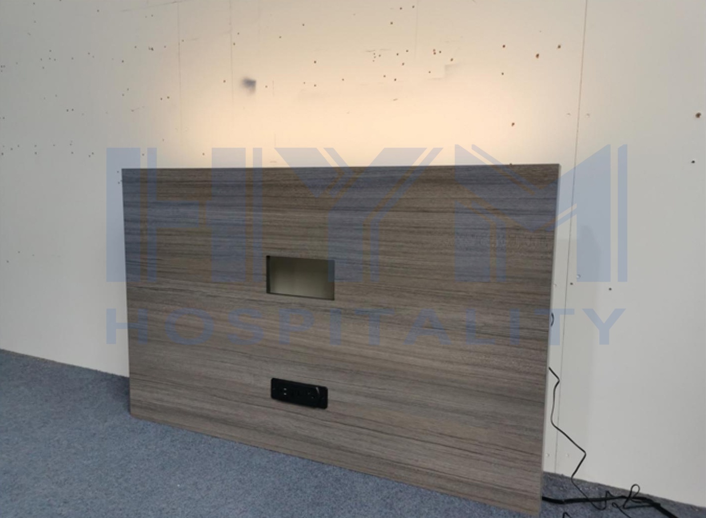 GR-311 wall-mounted hotel TV panel three-quarter angle view showing panel depth and recessed cable niche, hospitality casegoods