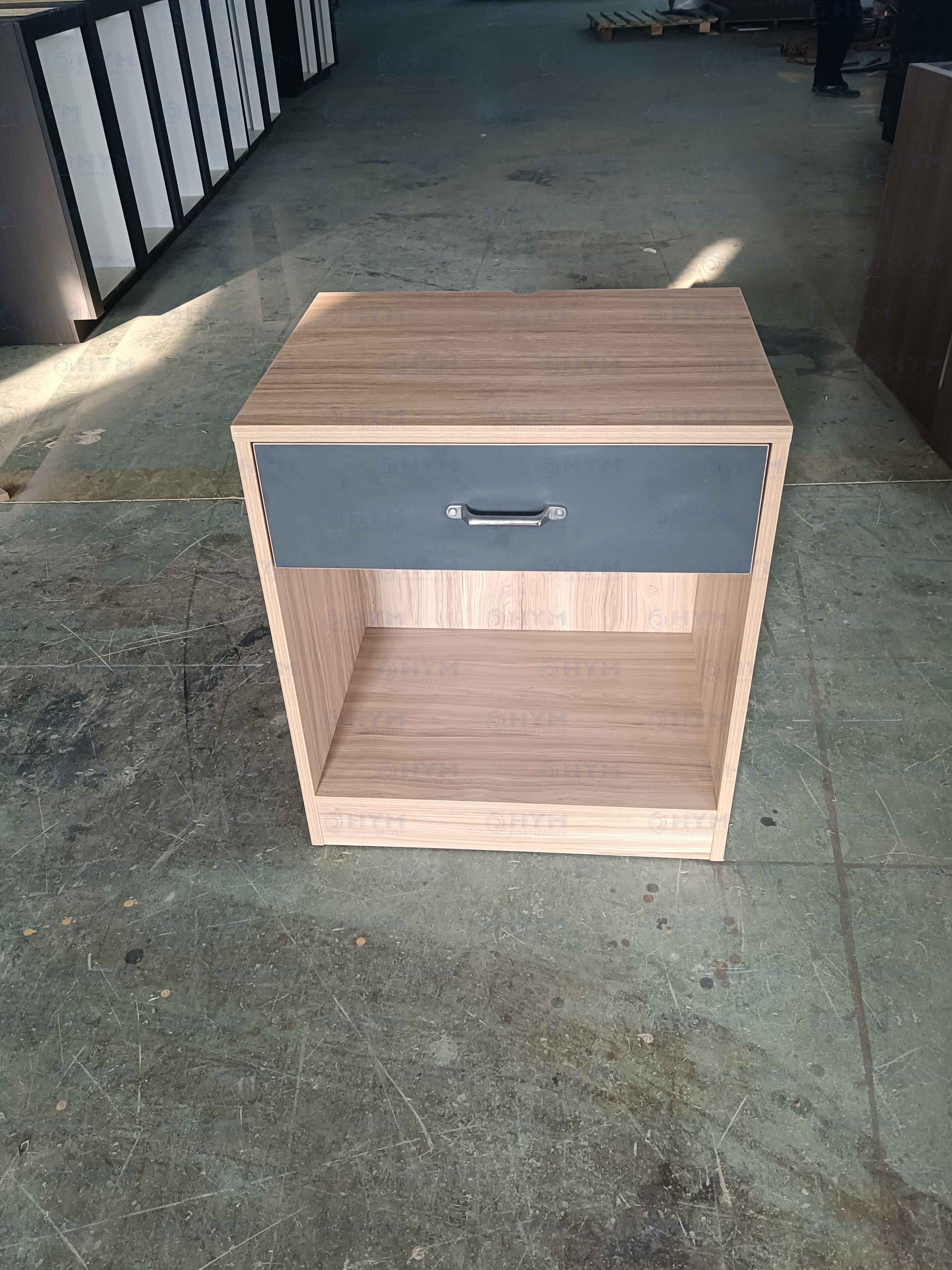 Front view of IHG brand-compliant CG-207 nightstand for Candlewood Suites, featuring an open storage cubby and reinforced hardwood solids.
