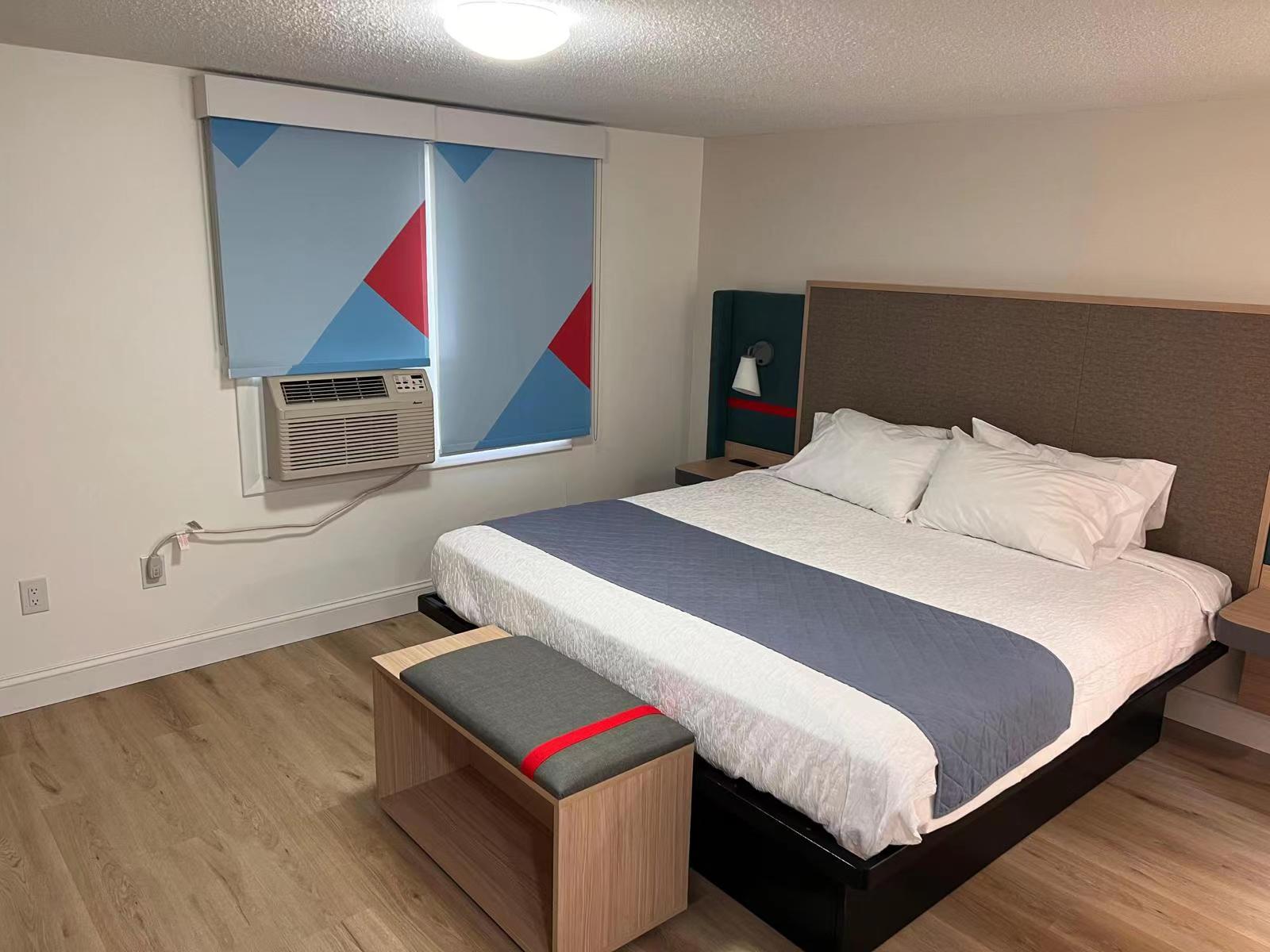 Complete turnkey FF&E furniture set for Avid Hotels by IHG, showcasing coordinated wood finishes and brand-standard color palette.