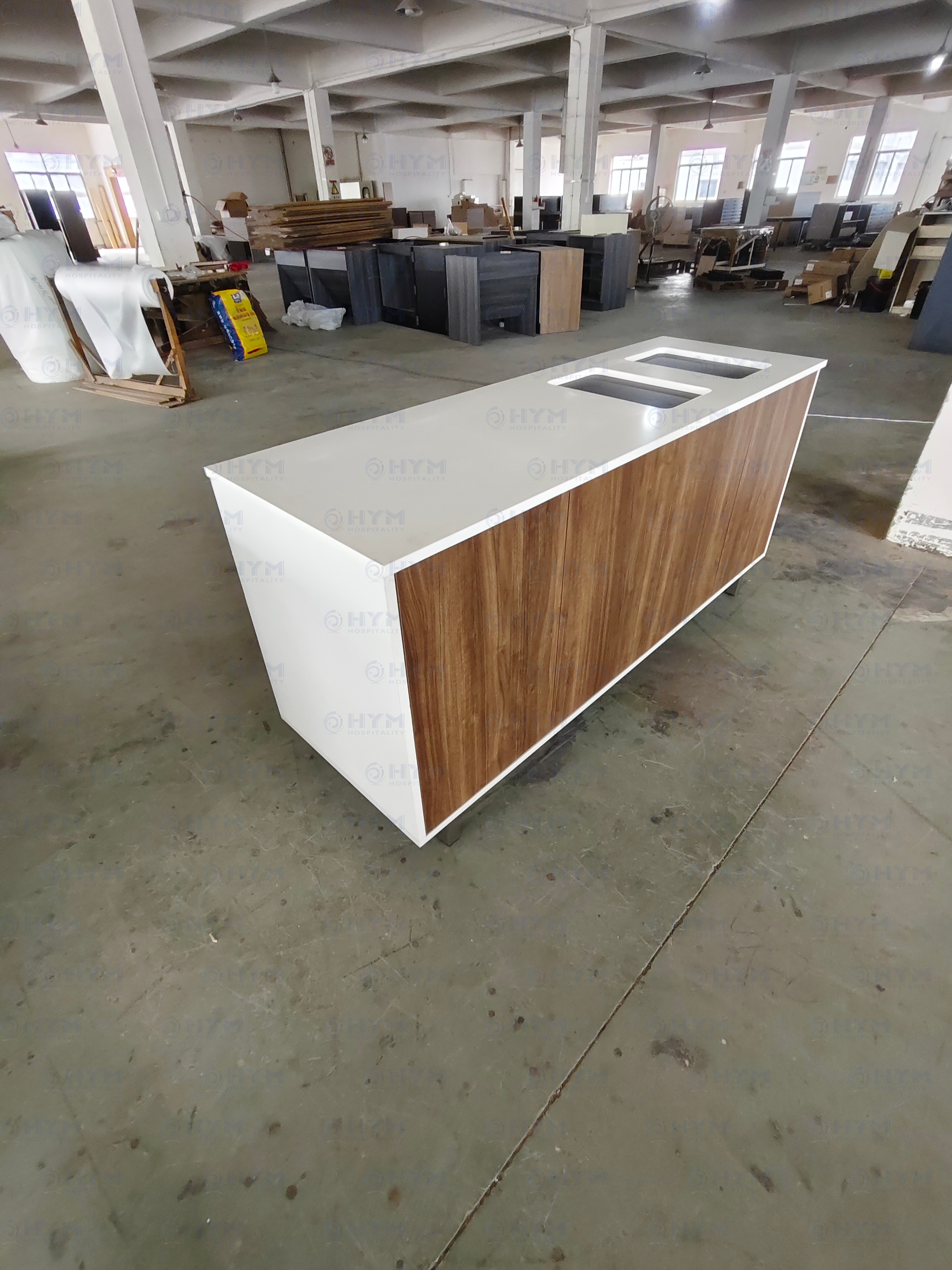 Real-world production photo of a brand-standard hotel trash console with moisture-resistant HPL and quartz integration.