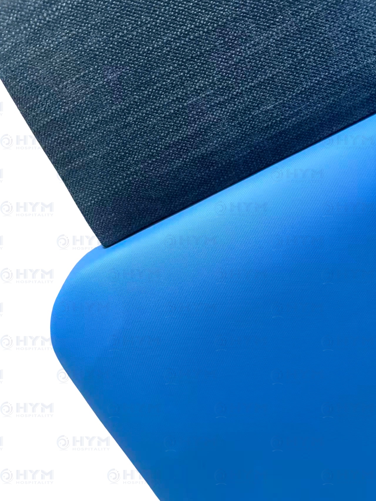Technical detail of a Hilton-standard headboard showing padded rounded edges and high-performance 100,000 double rub fabric texture.