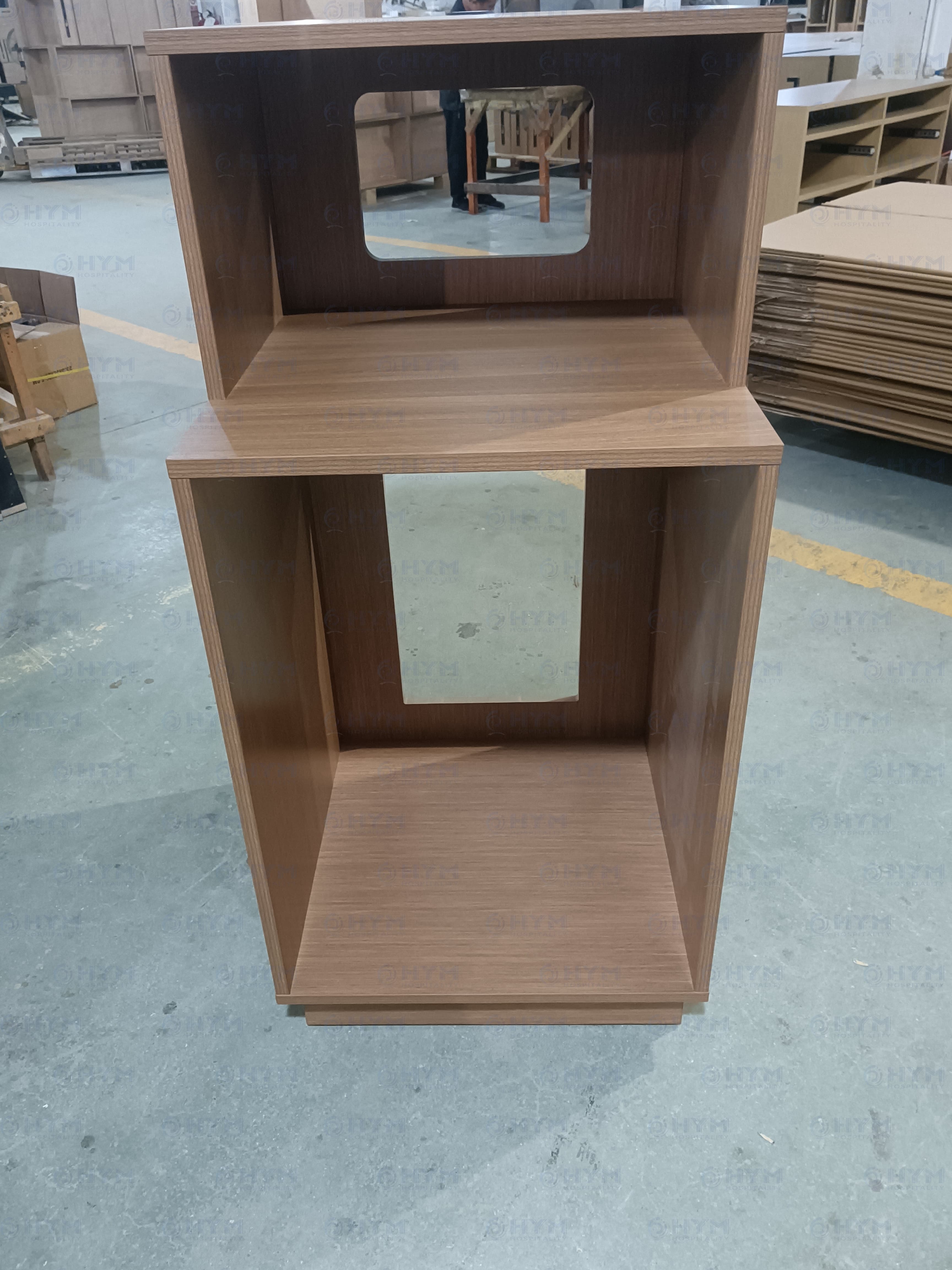 Marriott brand-compliant refrigerator and microwave combo cabinet for Fairfield Inn & Suites guestrooms, featuring an open-back design for appliance ventilation, pre-drilled cable management ports, and a high-durability wood-grain finish.